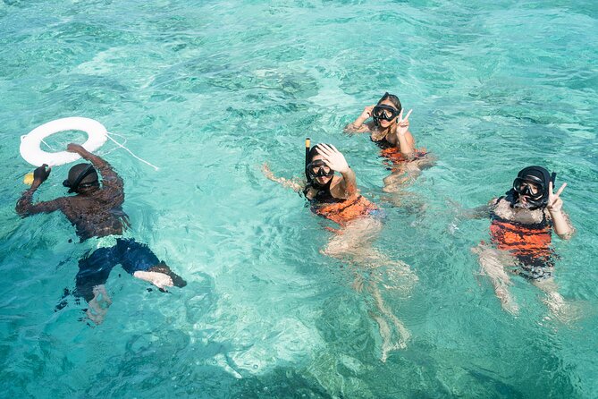 Pareja haciendo esnórquel en arrecife de coral en el Caribe