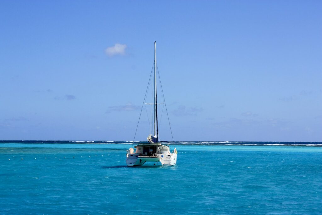White catamaran sailing on turquoise Caribbean water